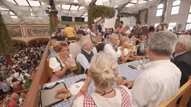 Image of an Octoberfest celebration with many people in classic attire