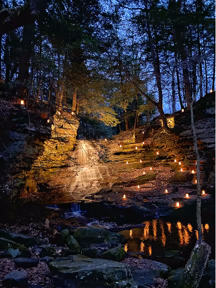 25-foot Honey Run Waterfall cascading over sandstone cliffs along a wooded trail near the Kokosing River