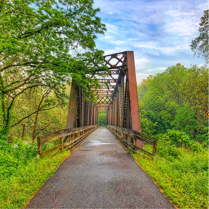 Paved Kokosing Gap Trail with a historic steam locomotive and caboose at the Gambier stop