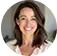 Smiling woman with shoulder-length brown hair wearing a white top.
