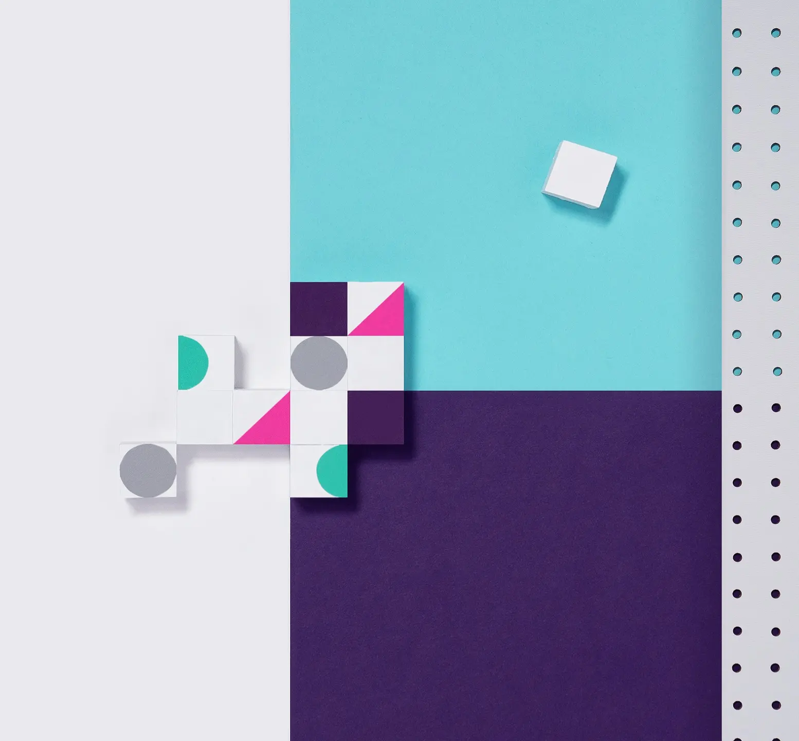 White blocks with teal, pink, and gray shapes arranged on a split blue and purple background.