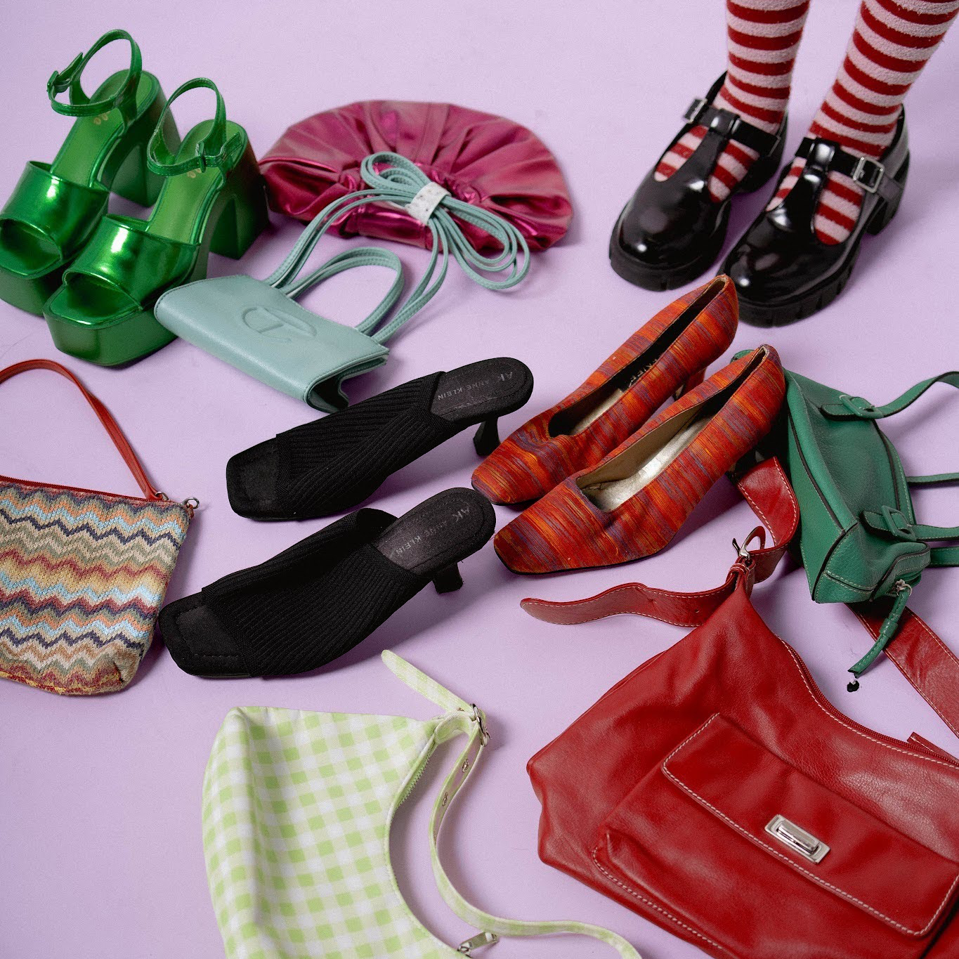 Fun, colorful shoes and purses scattered on the floor next to Zari's feet. Wearing black shoes and striped socks.