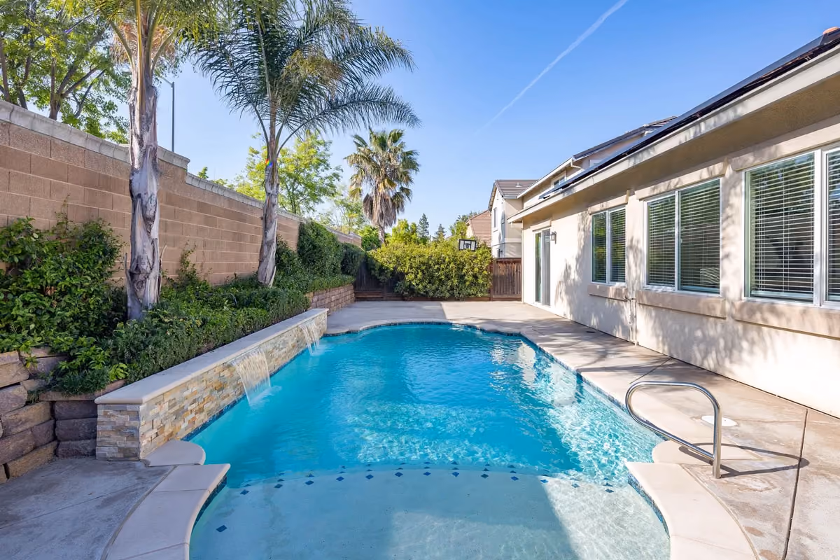 Sunny house with pool and palm trees