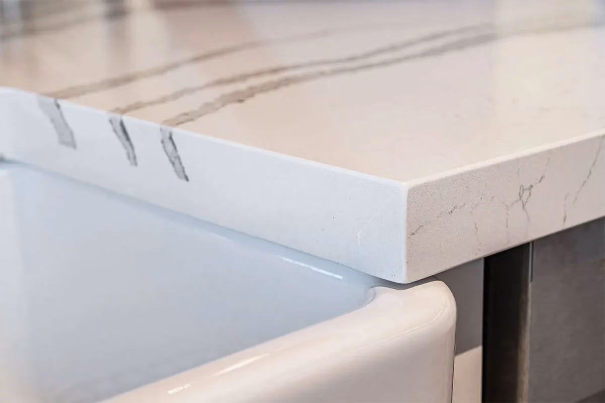 A clean kitchen sink and countertop up-close.