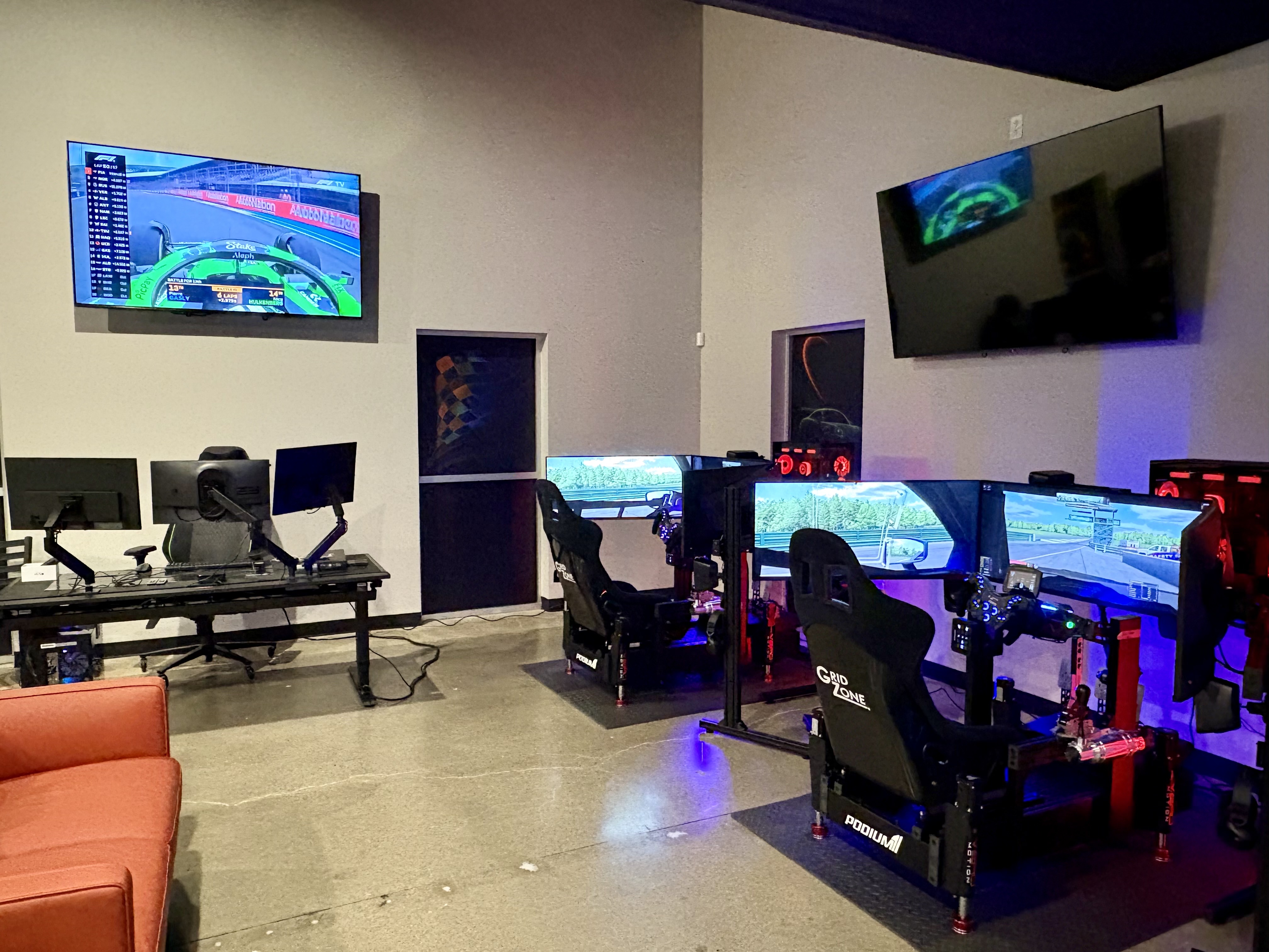 Multiple GridZone sim racing rigs set up side by side for competitive and group racing.