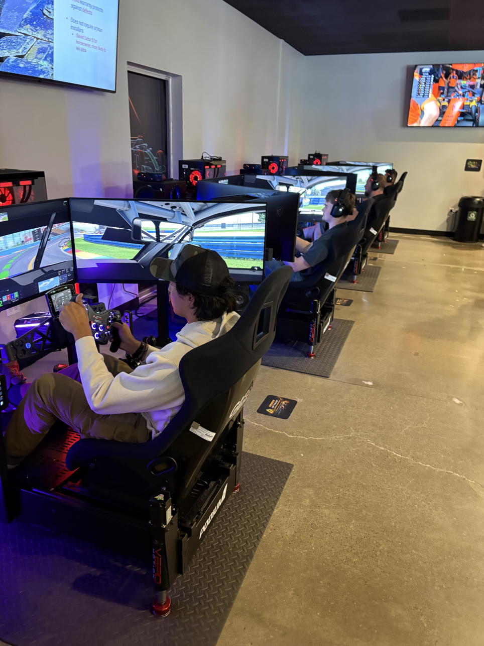 Neon racing car graphic representing GridZone sim racing experiences.