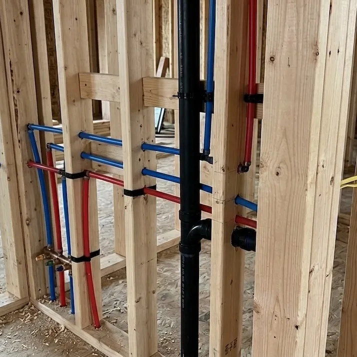 Calgary plumber reviewing plumbing drawings with a general contractor on site
