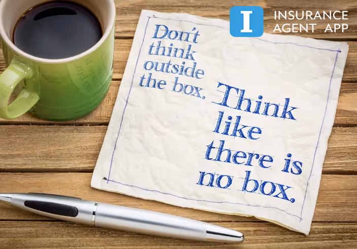 A handwritten napkin beside a coffee cup and pen reading: Don't think outside the box. Think like there is no box.