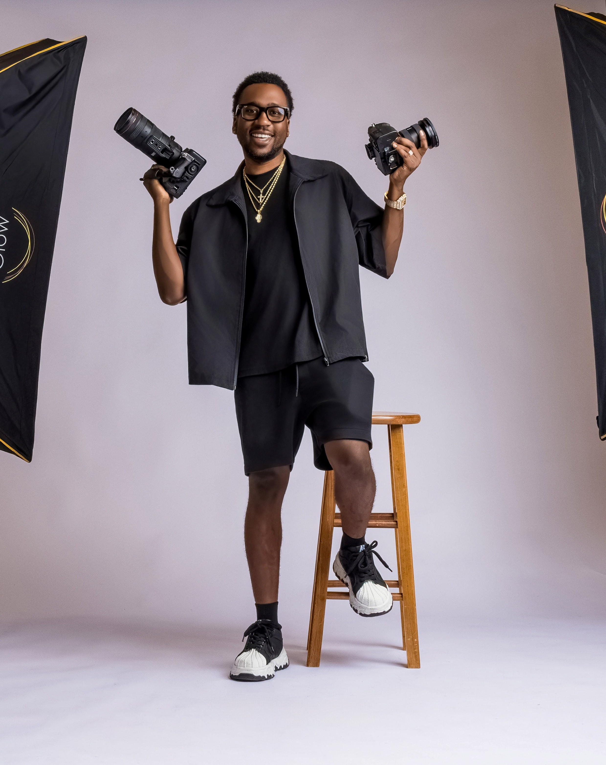 Starr Visualz videographer holding two cameras in a studio