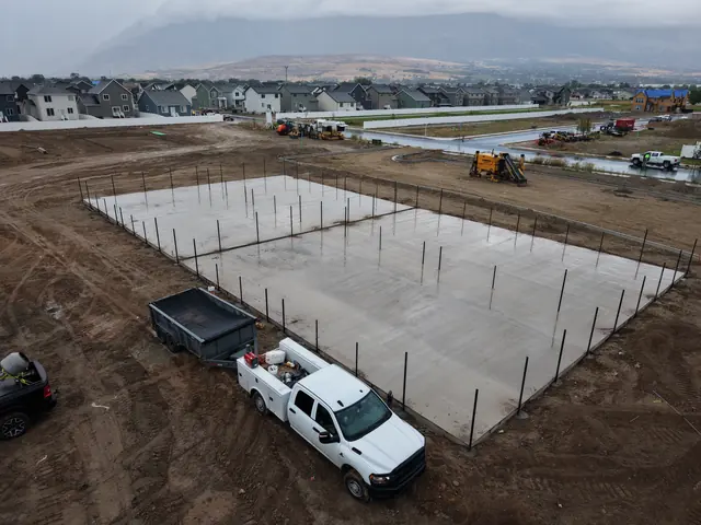 Newly poured court slab with perimeter fence posts installed.