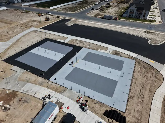 Light gray court color coating over a dark base layer.
