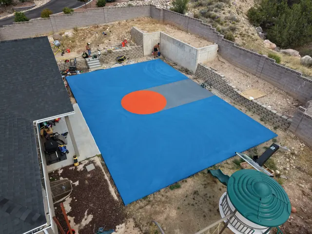 Blue basketball court coating and orange center circle before white game lines are added.