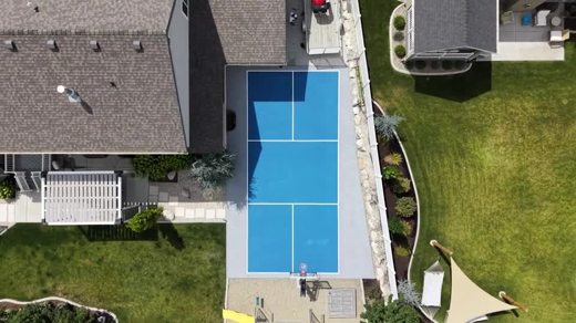 A blue backyard court viewed directly from above.