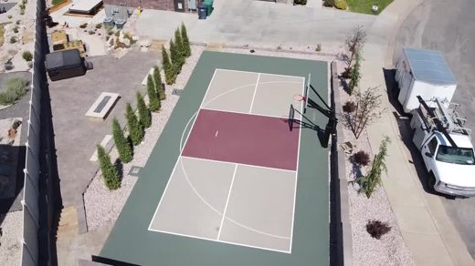 A court with a red key, tan playing area, and green surround.