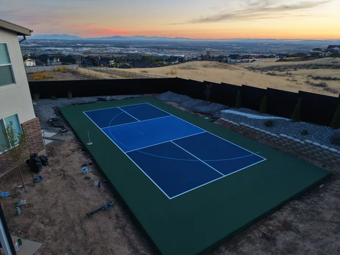 Blue and green Pleasant View court with a sunset valley backdrop