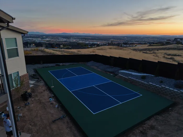 Pleasant View backyard court and surrounding valley in evening light