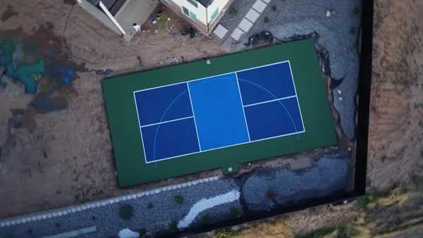 An overhead rotation shows the completed court layout and its place in the backyard.