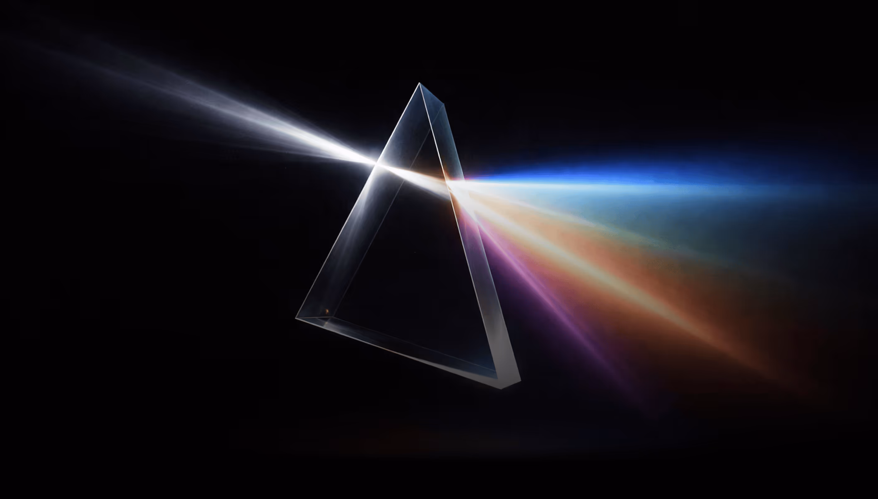 Light beam entering a glass prism and dispersing into a spectrum of colors against a black background.