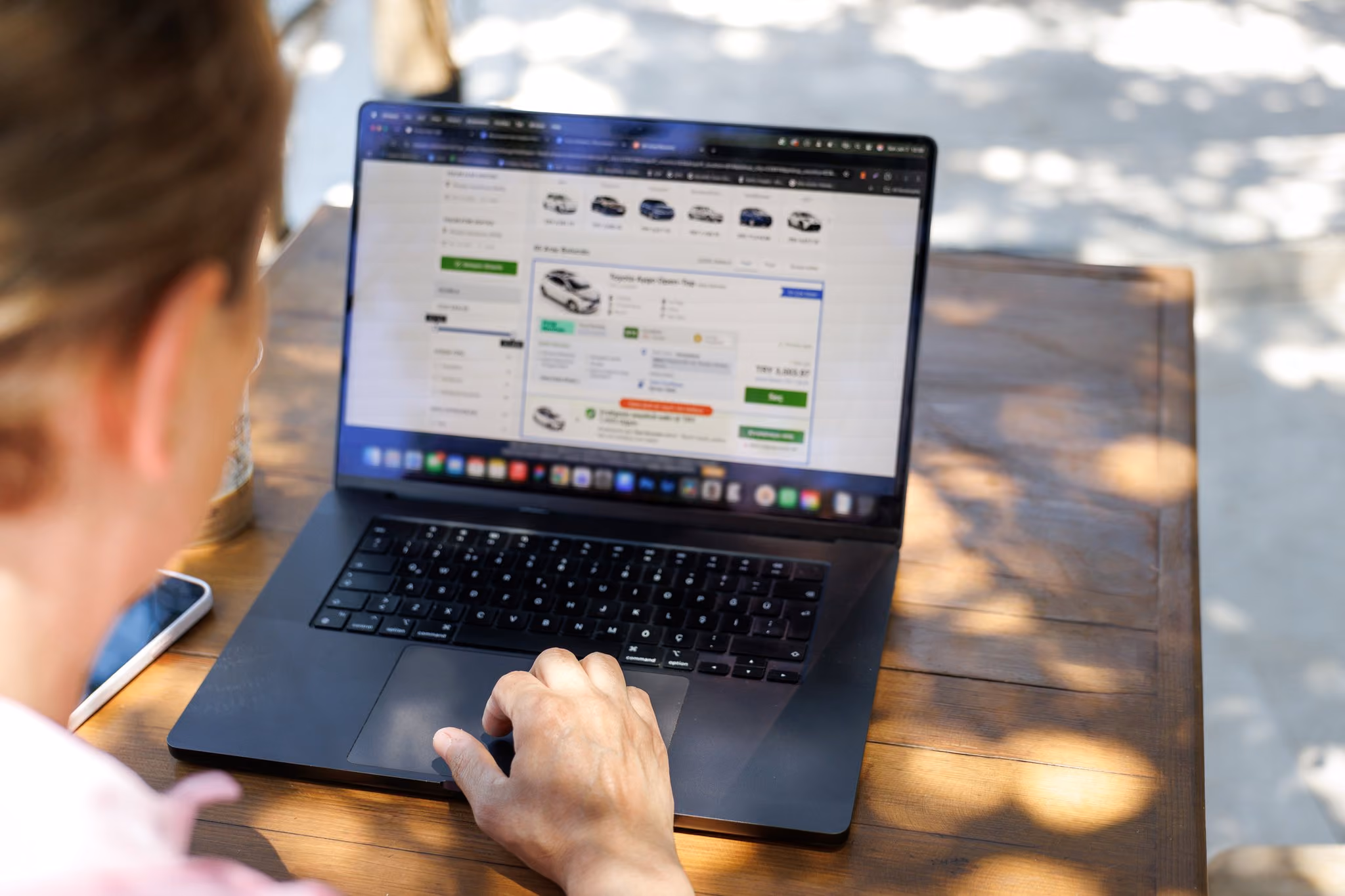 Woman comparing vehicle prices on a laptop