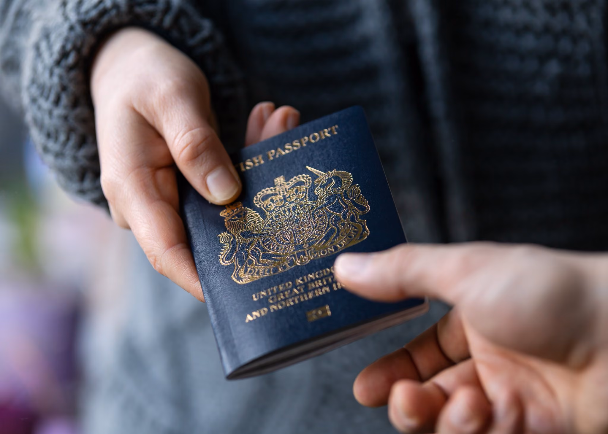 A British passport being handed over