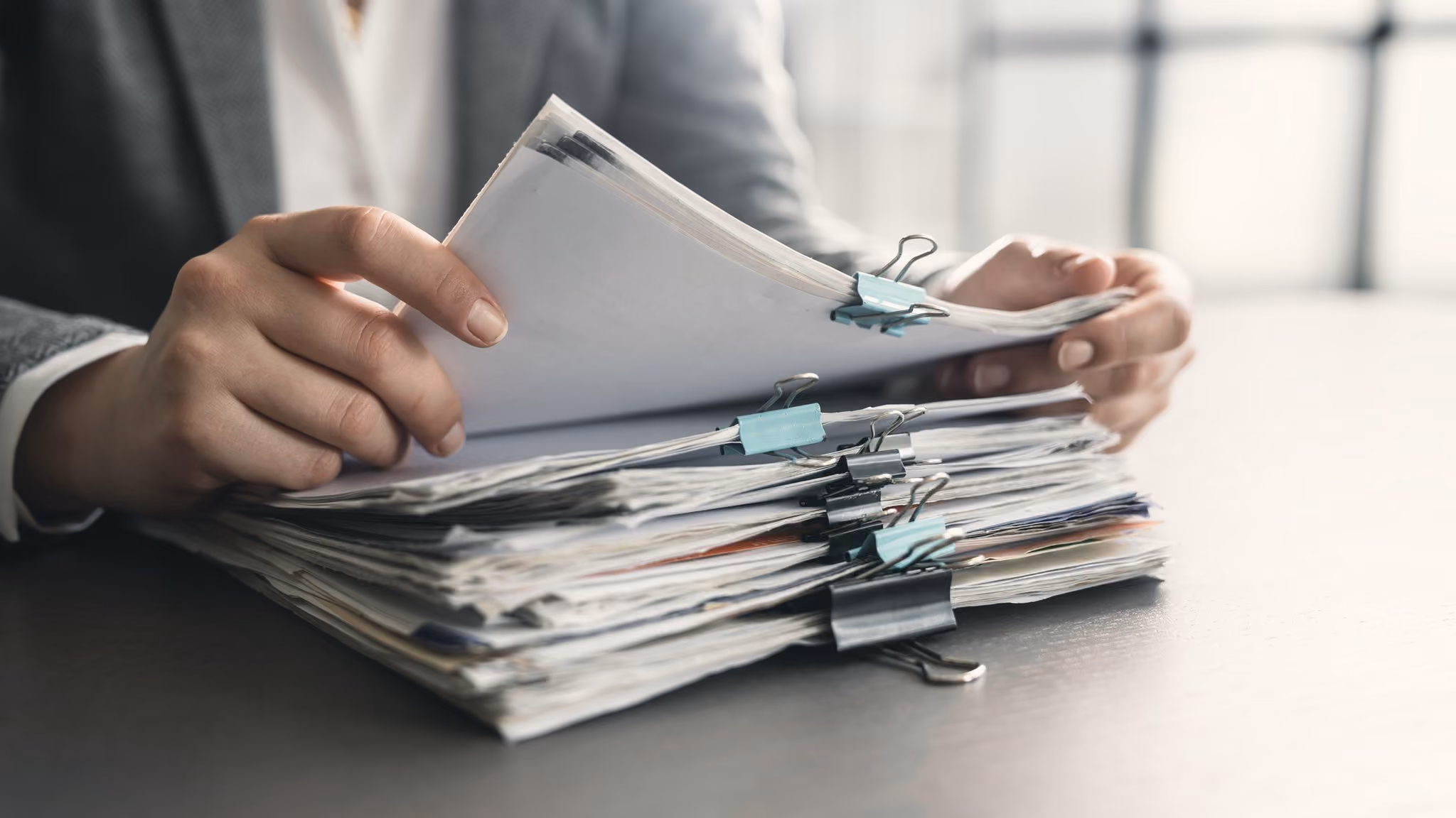 Stack of clipped documents and files in an office