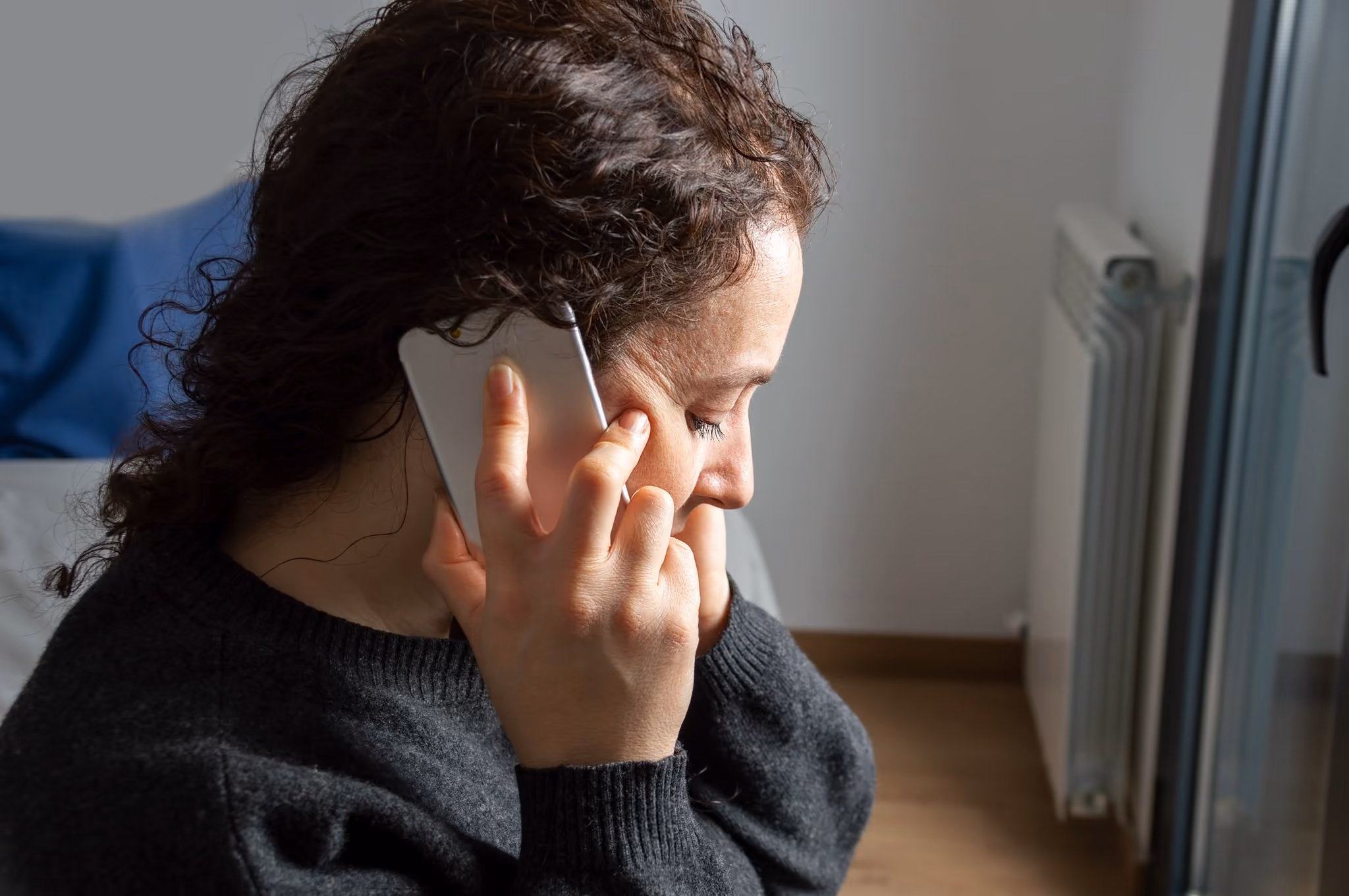Woman taking a phone call at home