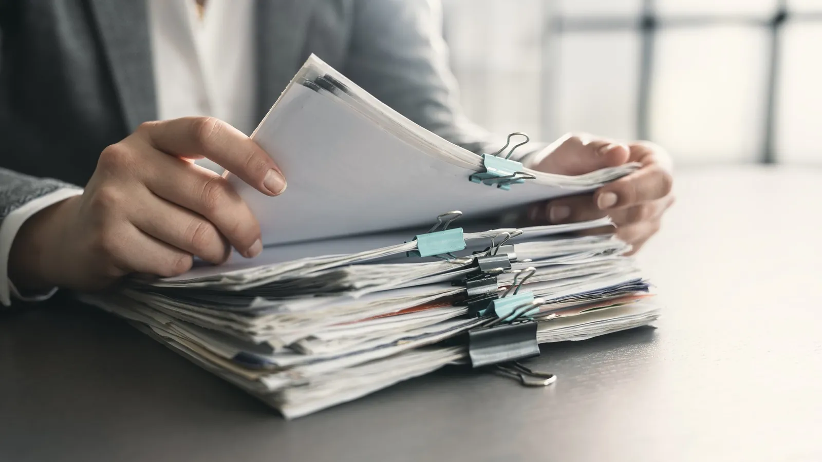 Stack of clipped documents and files in an office