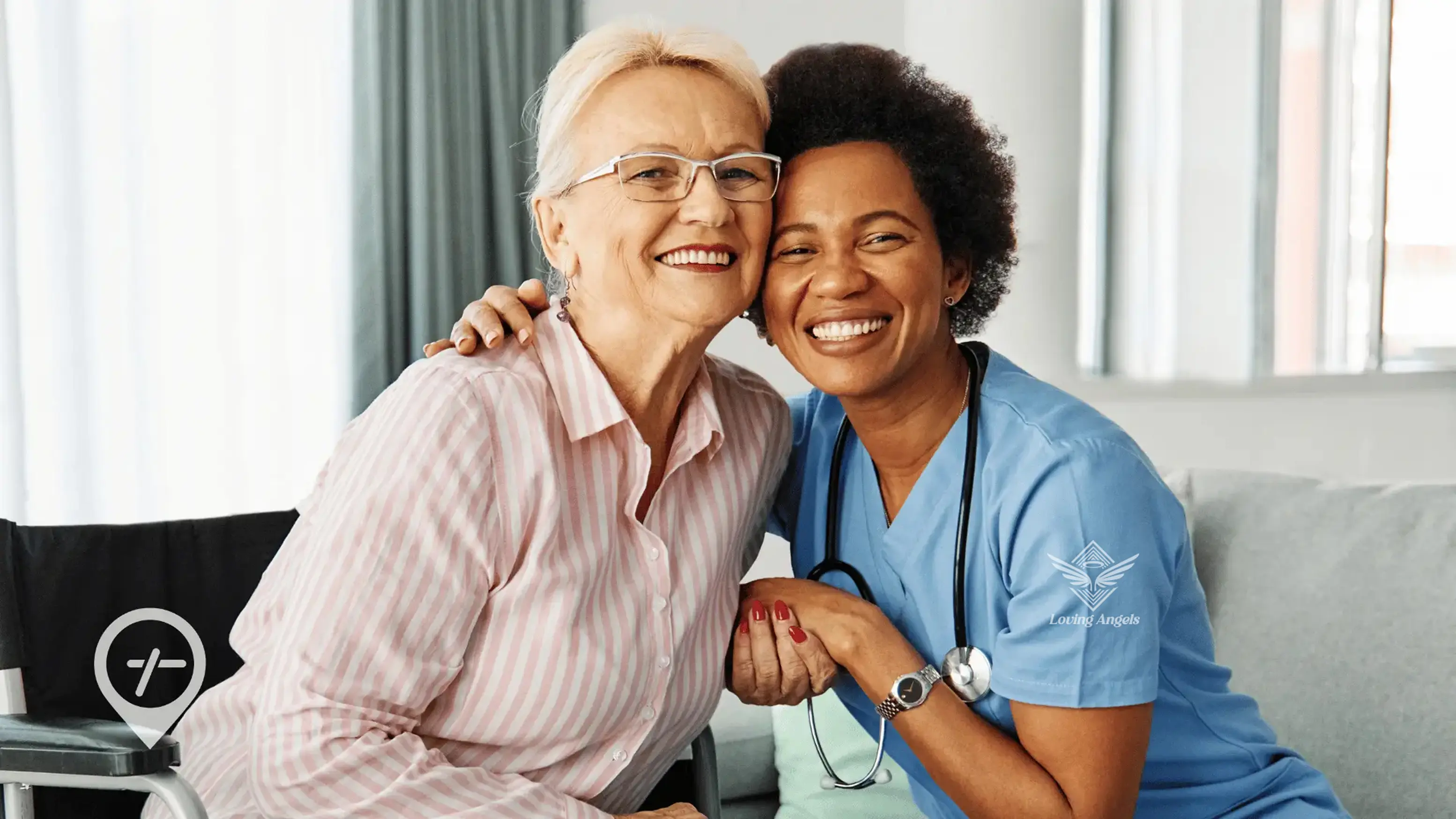 Smiling elderly woman hugging cheerful female nurse in scrubs with stethoscope in bright room.