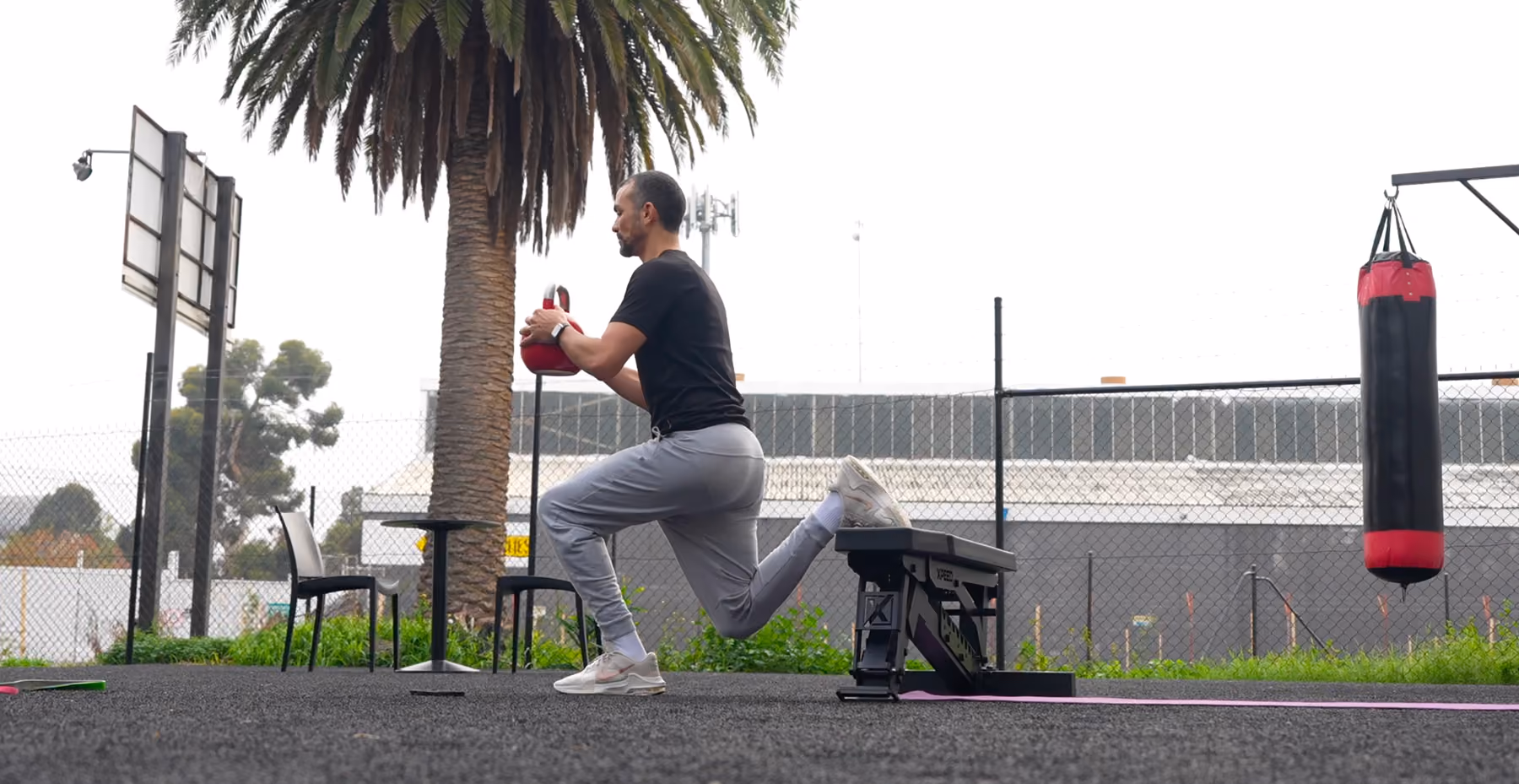 man bulgarian split squats with medecine ball