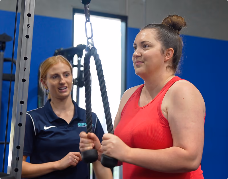 Chantel helping client in the gym