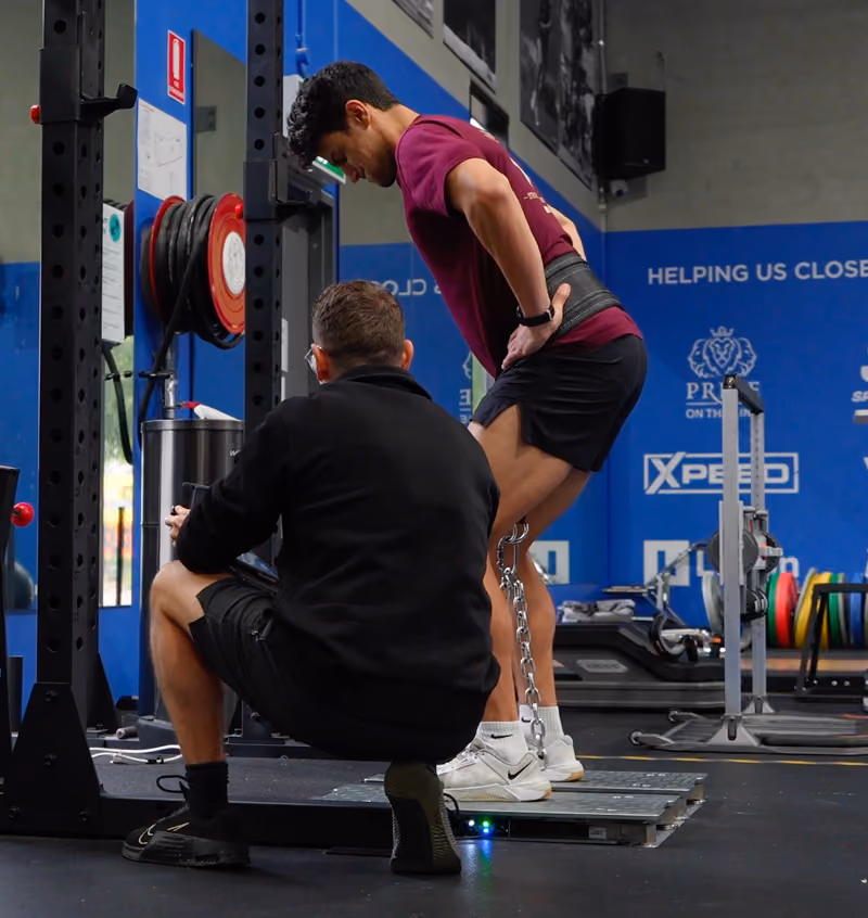 chris helping athlete client in sepsa gym