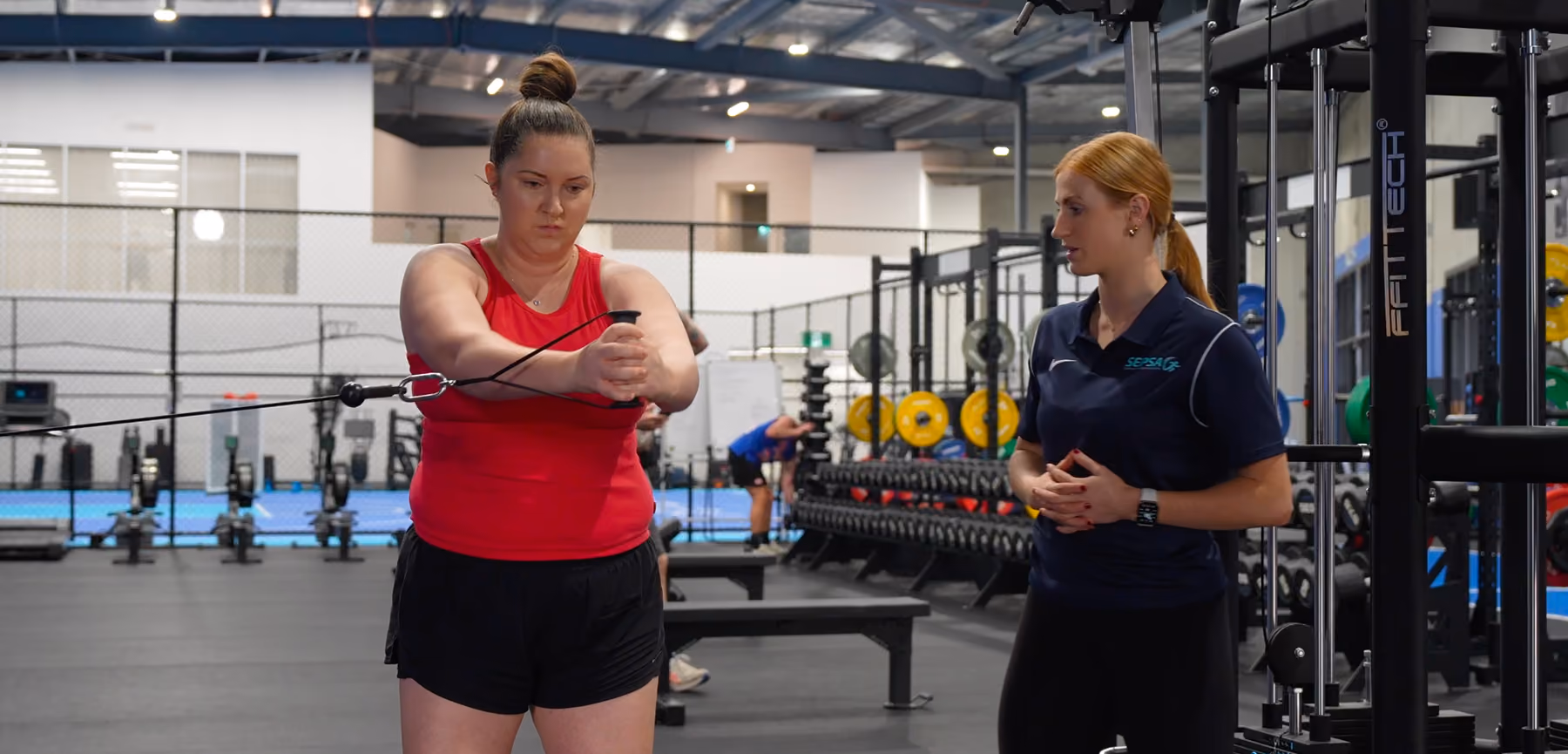 chantel helping client with pull machine