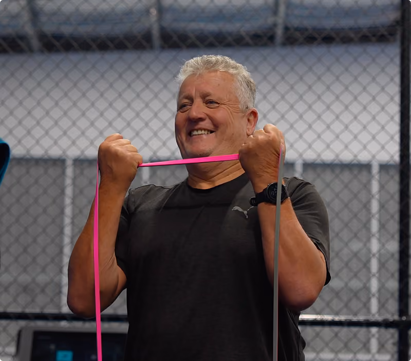 middle aged man lifting exersize band at peaq