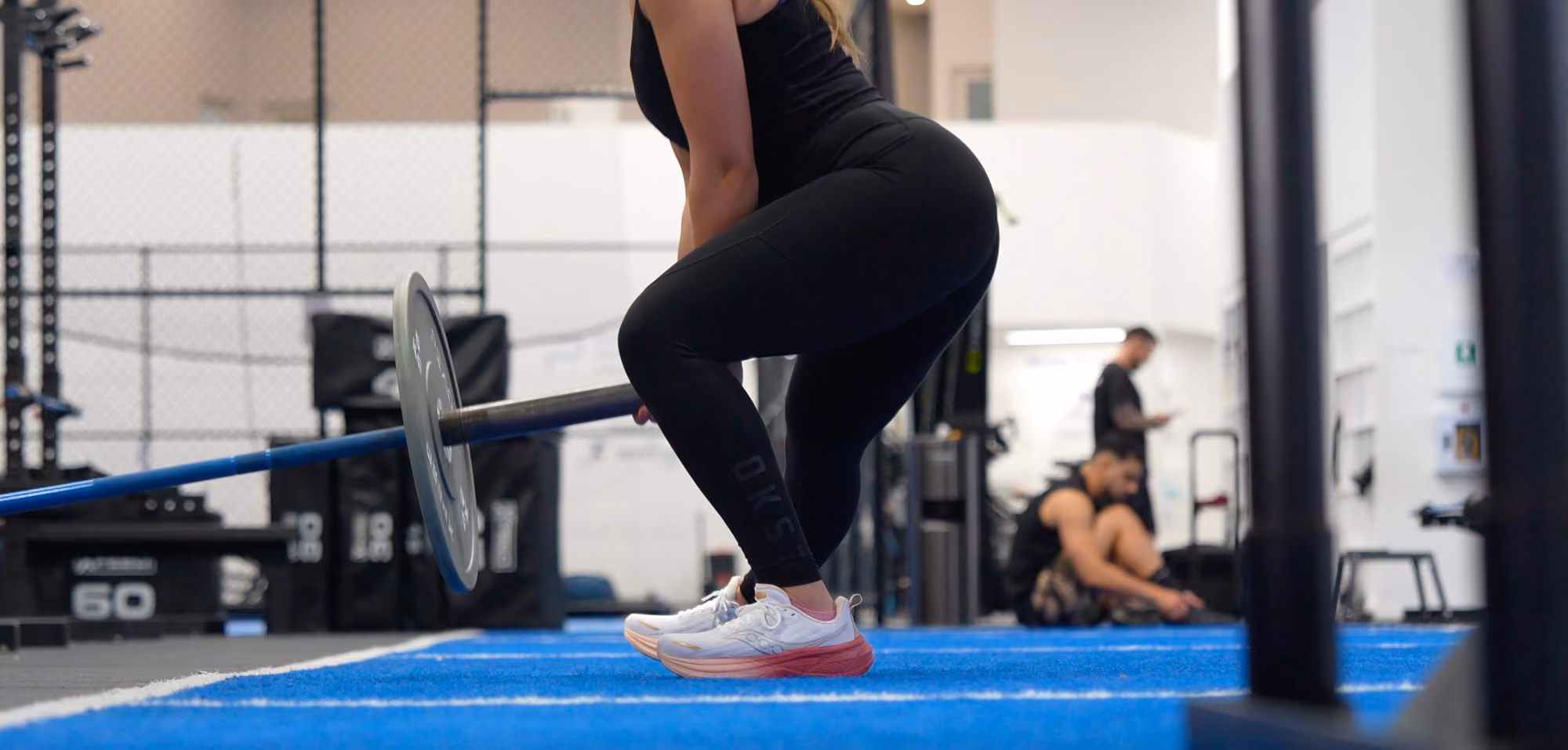 woman lifting heavy weight in gym