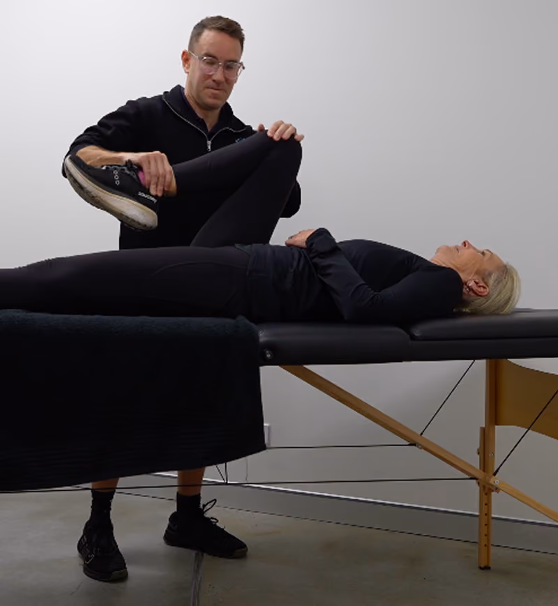 chris helping client with rehab and stretching