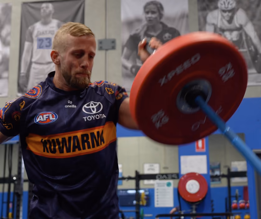 man lifting heavy weight above head