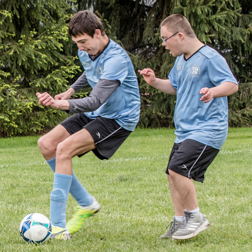 Two boys playing a soccer game