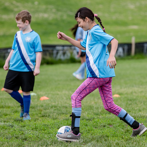A girl playing soccer