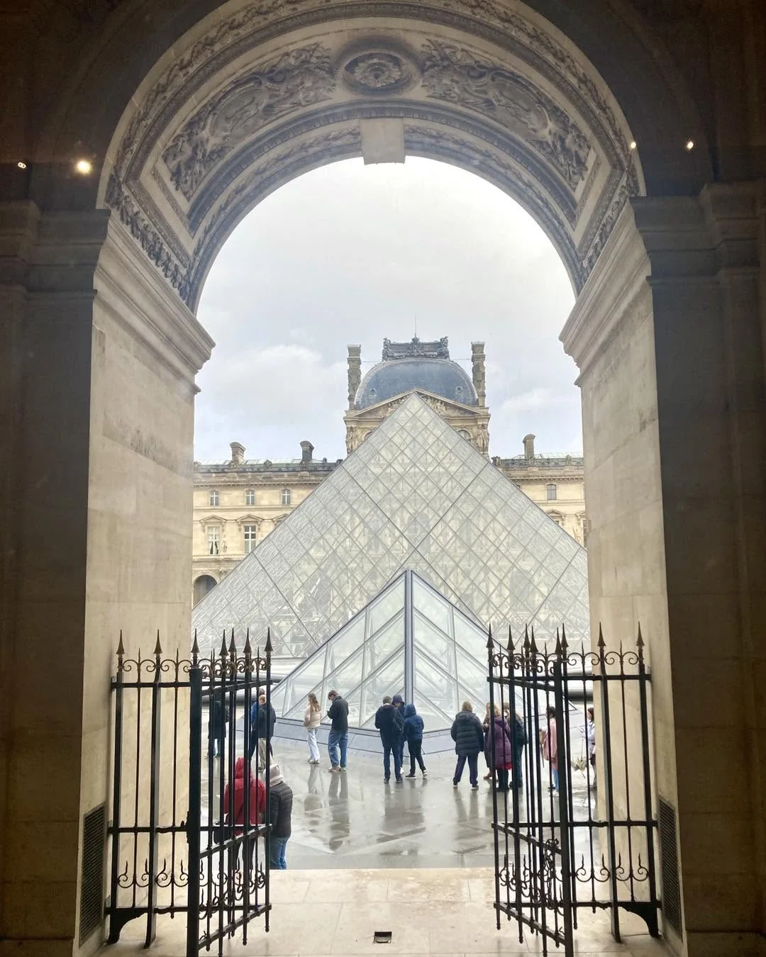 The Louvre pyramid seen through an arch