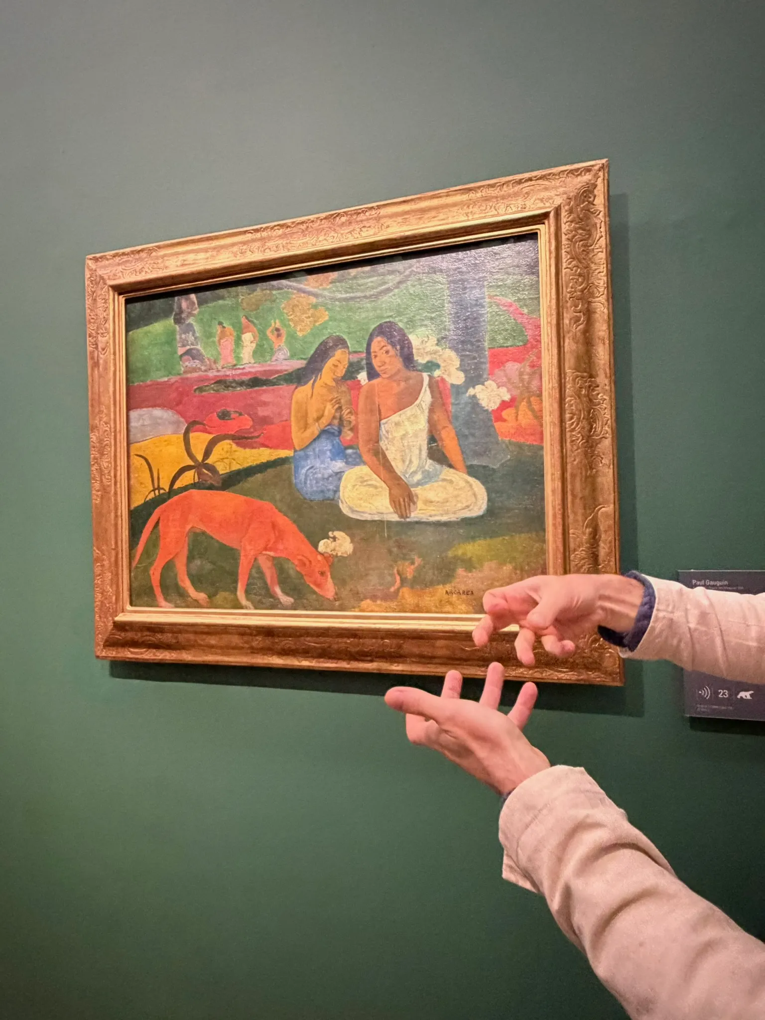 An artist studying a painting in a museum