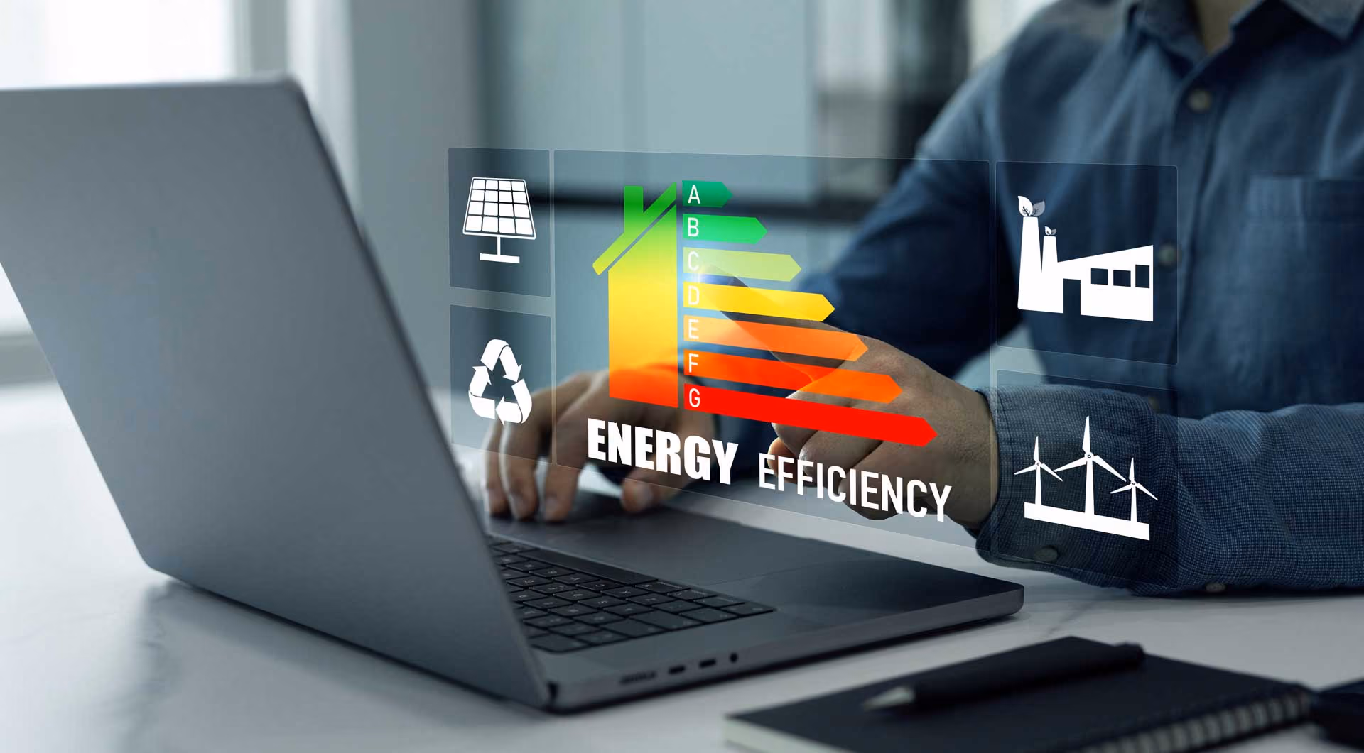 Person using a laptop displaying energy efficiency graphics with a colorful bar chart and icons.