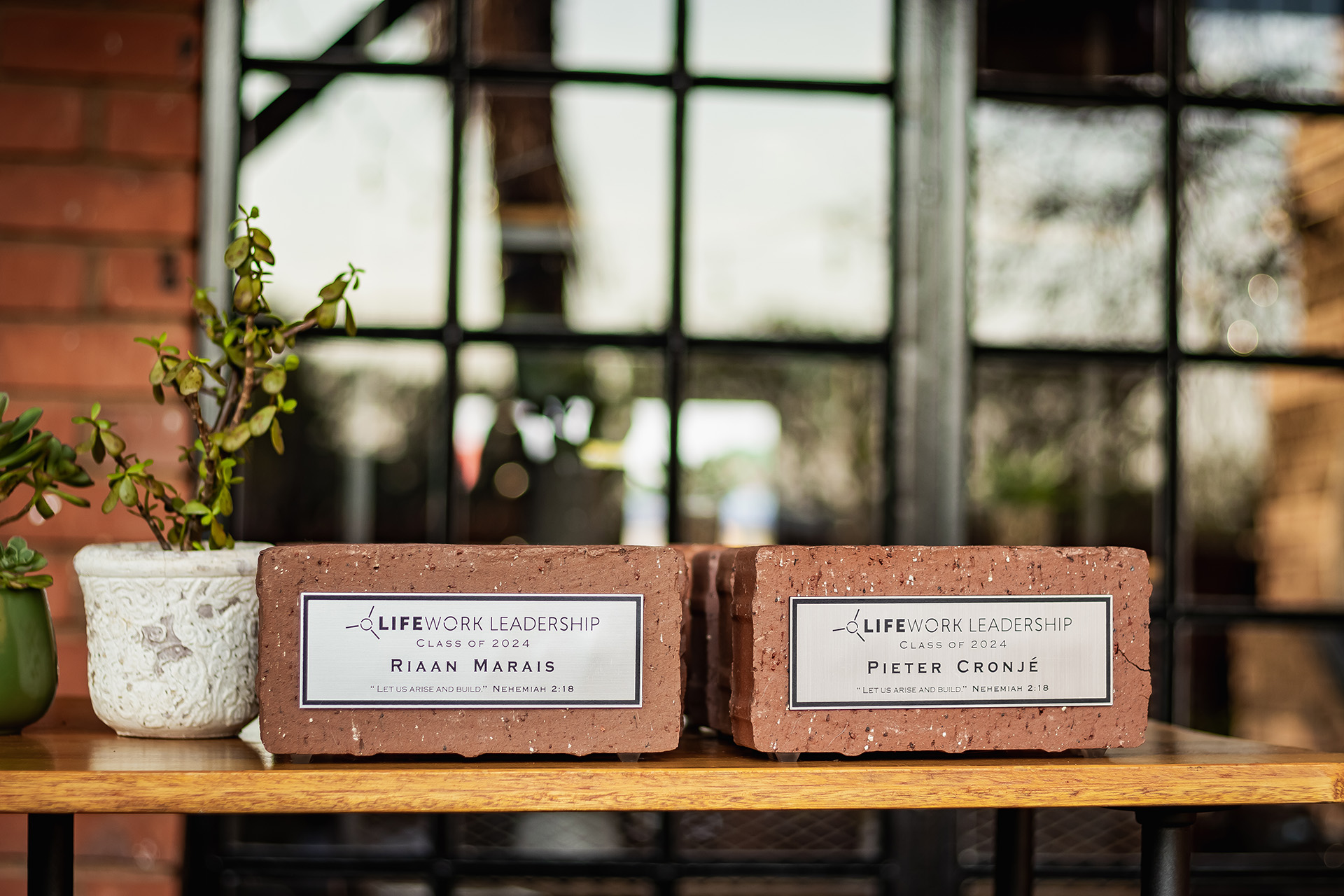 Two engraved bricks labeled Life Work Leadership Class of 2024 with names Riaan Marais and Pieter Cronjé.