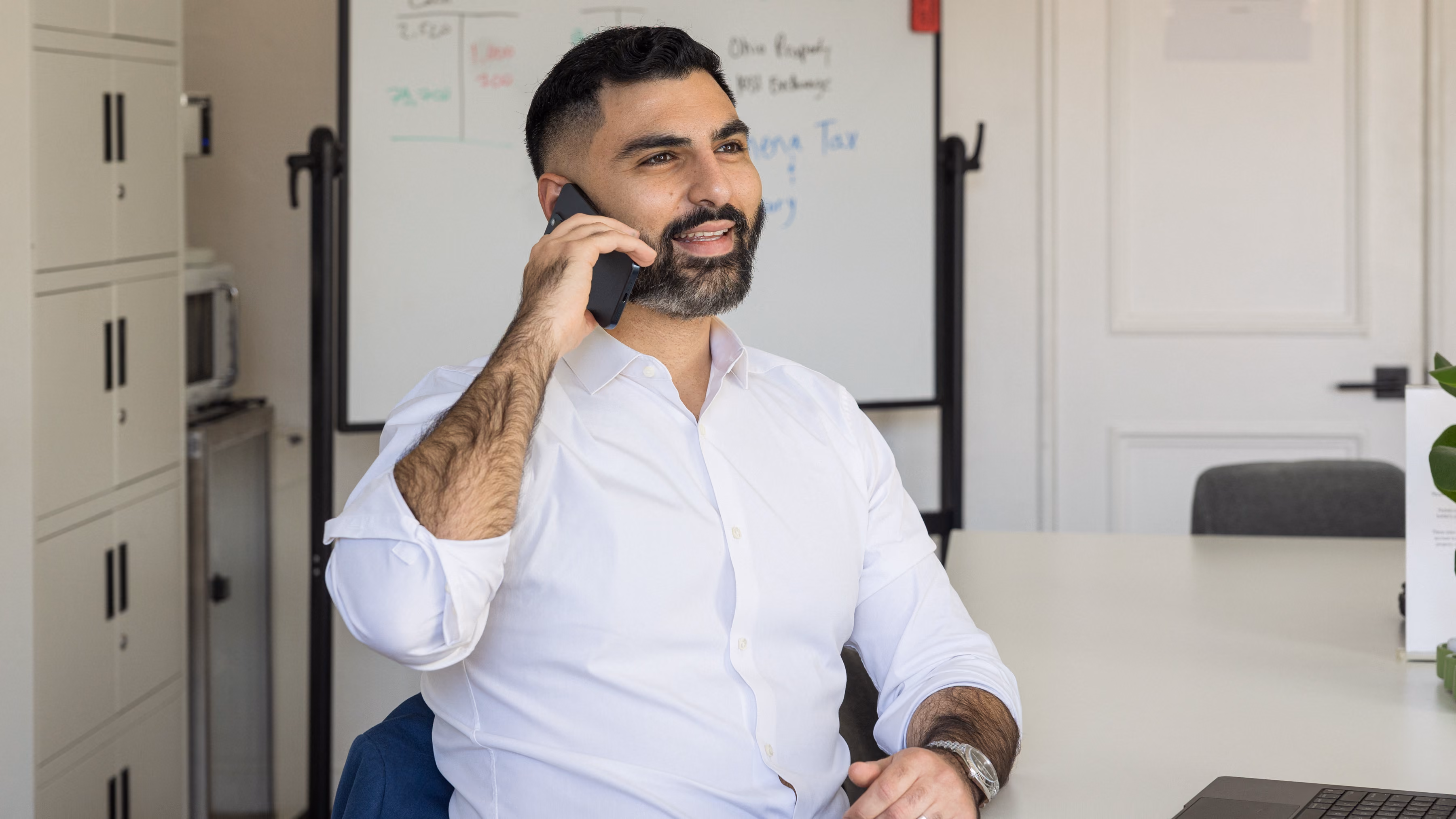 Edmond Petrosyan, founder of Athena Tax & Advisory, on a phone call in his office