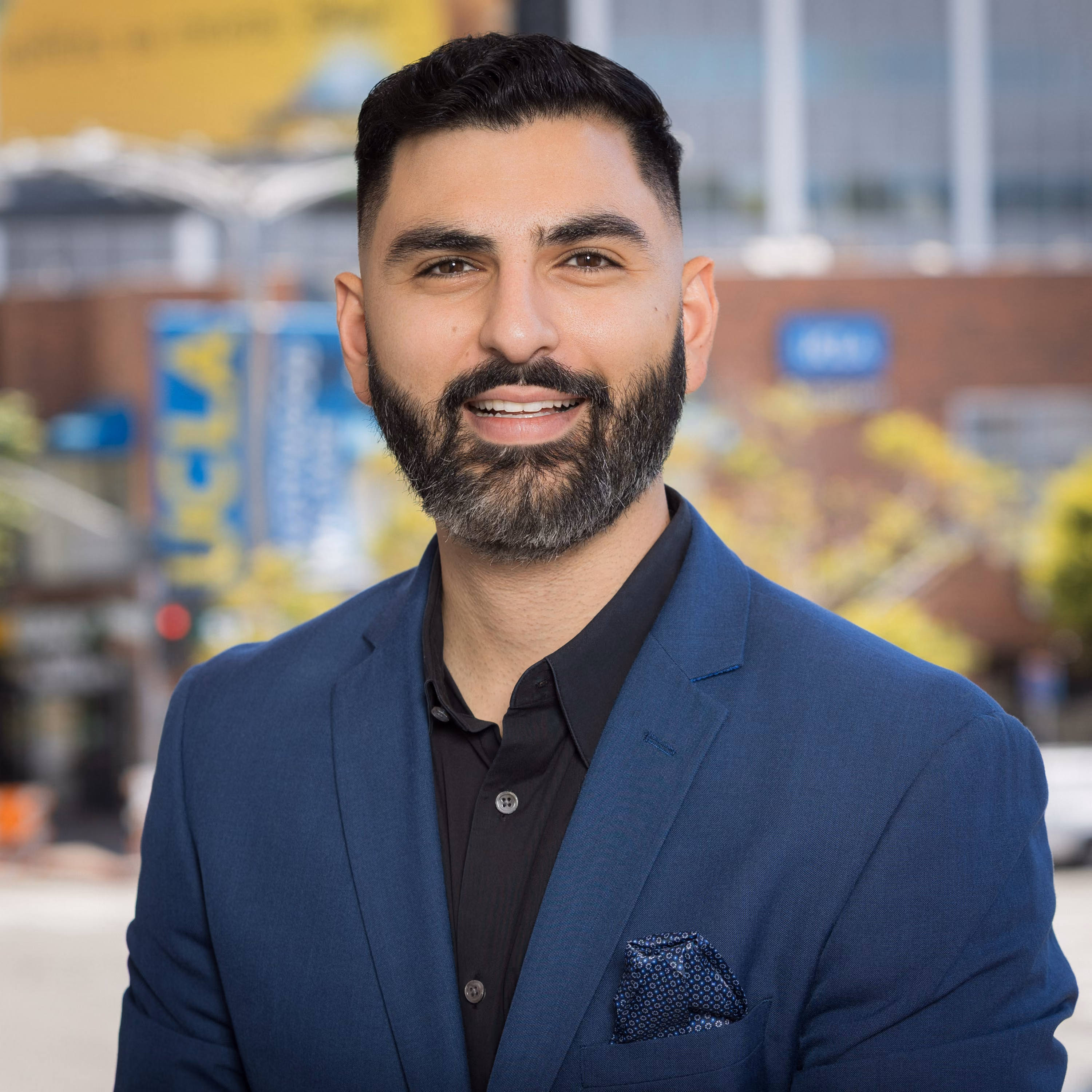 Portrait of Edmond Petrosyan, founder of Athena Tax & Advisory, smiling outdoors in a blue suit
