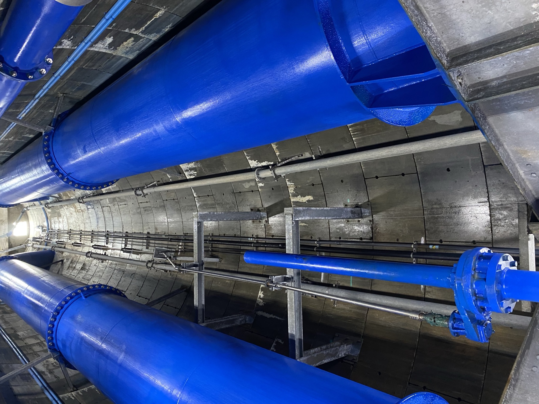 Blue trunk mains running through a refurbished shaft