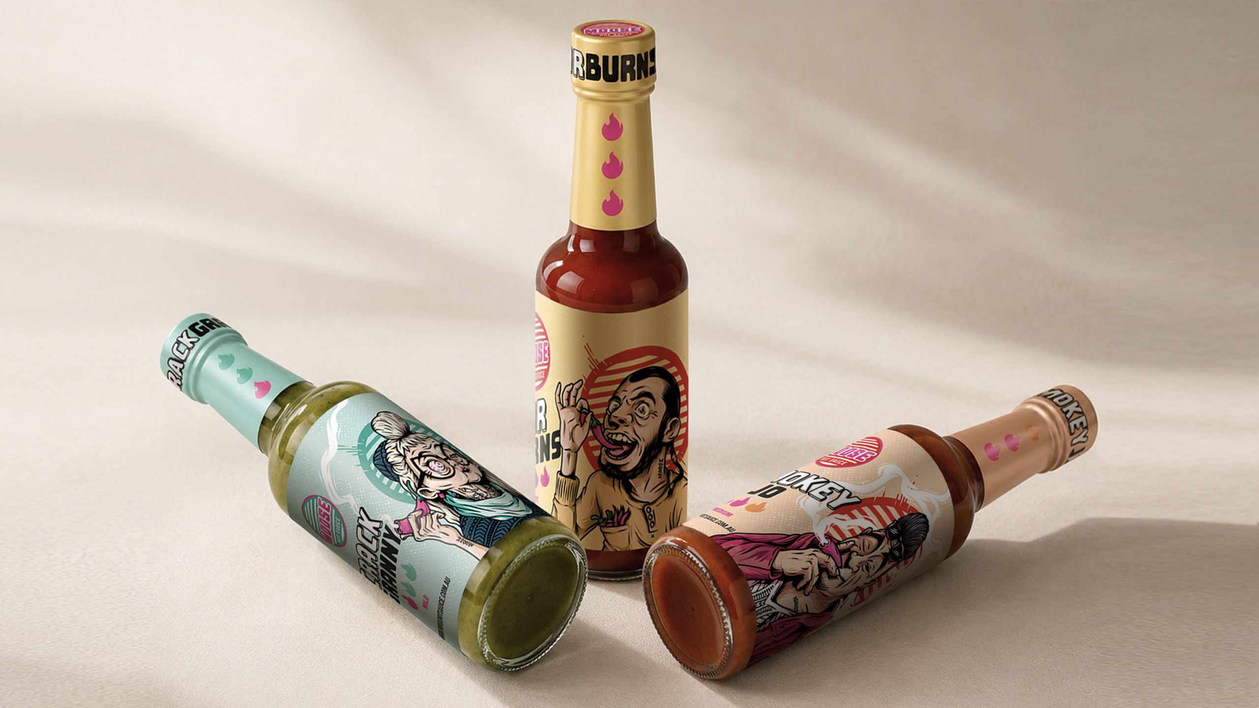 Three Moose Hot Sauce bottles arranged together, featuring Crack Granny, Smokey Jo and Mr. Burns character labels.