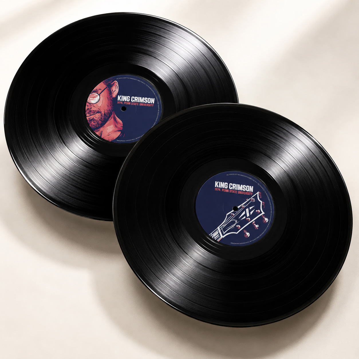 Two King Crimson vinyl records with illustrated Robert Fripp and guitar artwork on the centre labels.