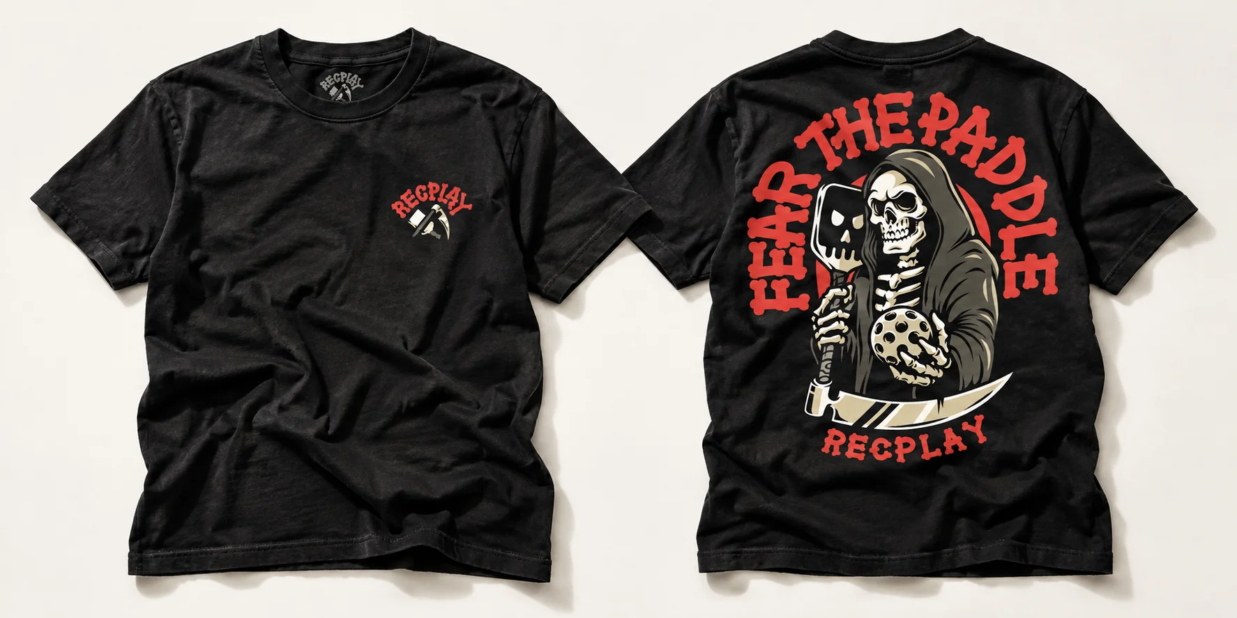 Front and back views of a black RecPLAY Fear the Paddle T-shirt featuring a Grim Reaper with a pickleball paddle and ball.