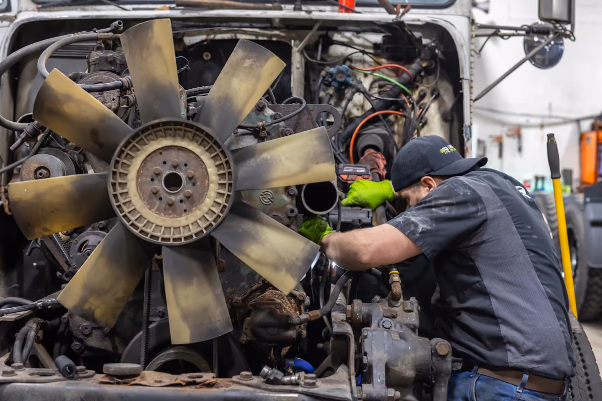 Diesel mechanic performing repairs on diesel engine