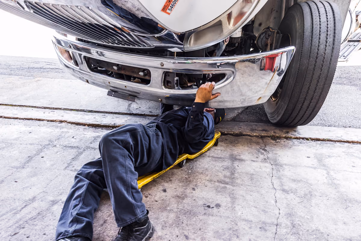 Mobile diesel mechanic performing emergency roadside assistance on commercial fleet truck